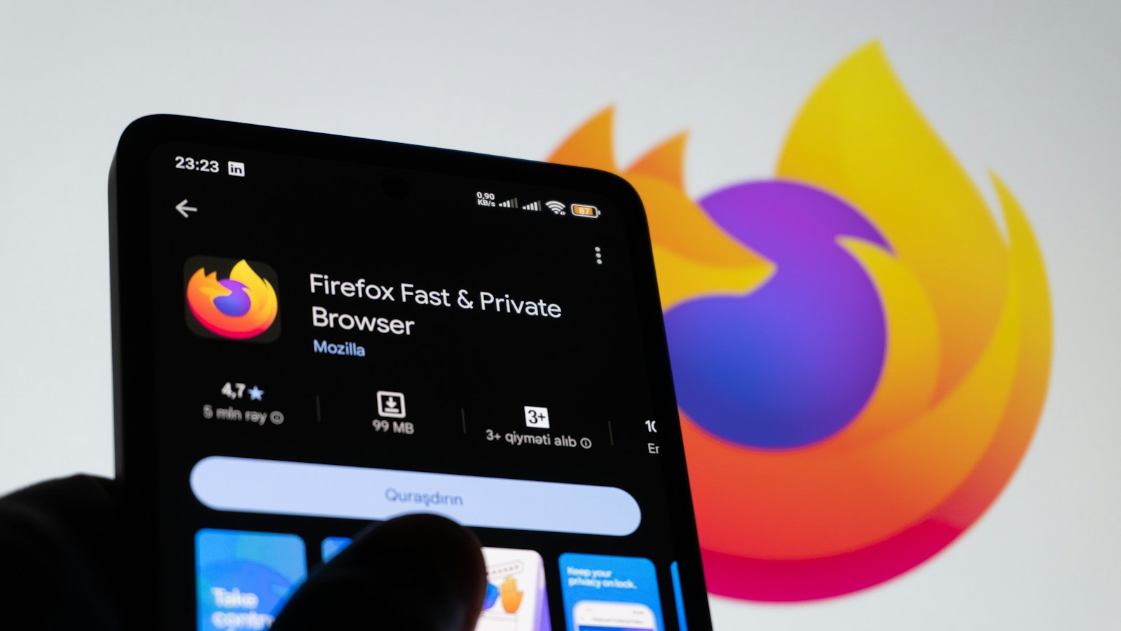 A smartphone displaying the Firefox browser app and logo.