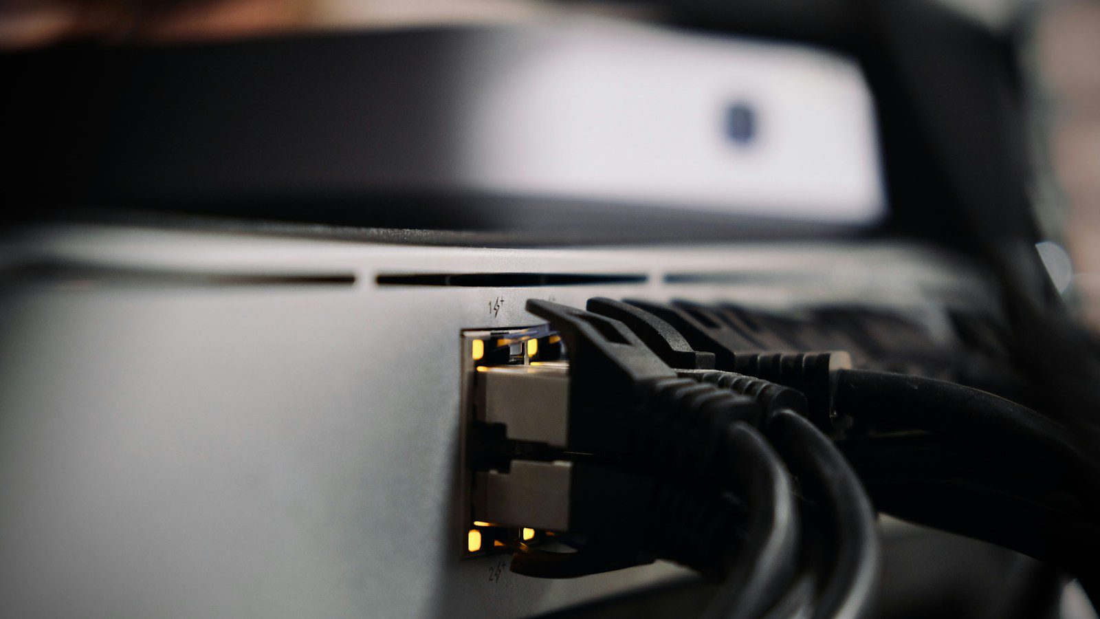 Ethernet cables connected to network equipment in a server rack.