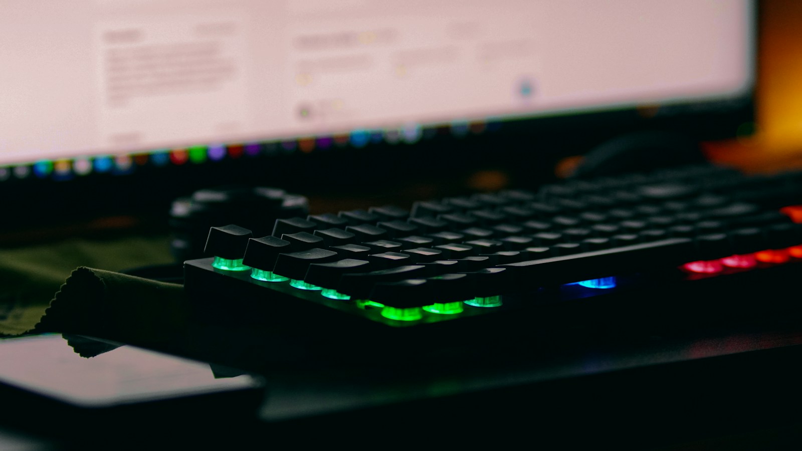 An illuminated gaming keyboard on a desk.
